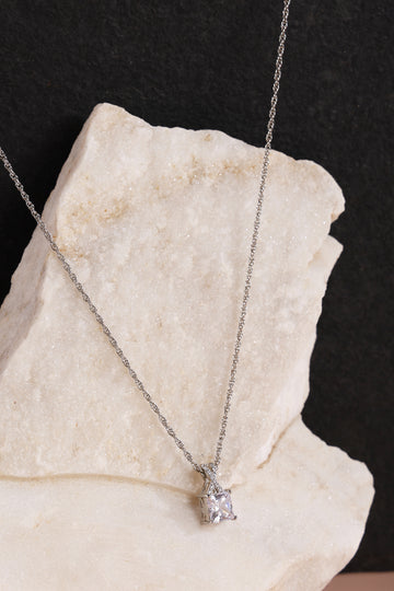 Bow with a princess cut drop pendant